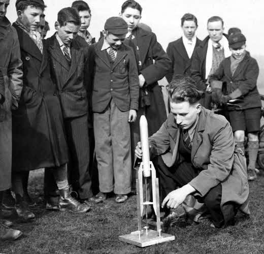 W. Heeley adjusting a rocket in a launch rack