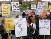 Placards to the front of him
